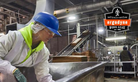 Worker wearing bump cap in factory. Ergodyne Tenacious Work Gear logo