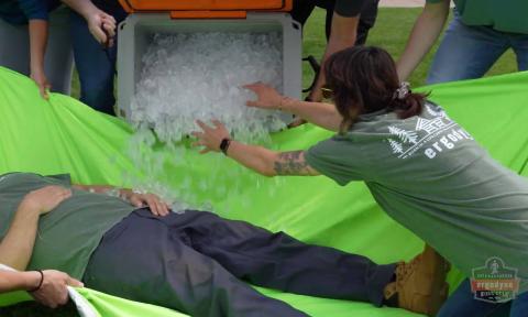 People covering unconscious person with ice