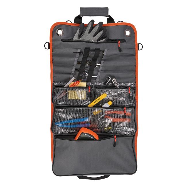 Open view of propped roll up tool bag with zippered pockets