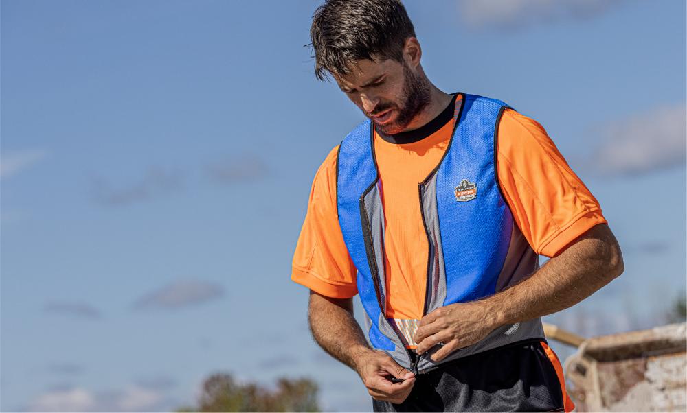 Worker putting on cooling vest