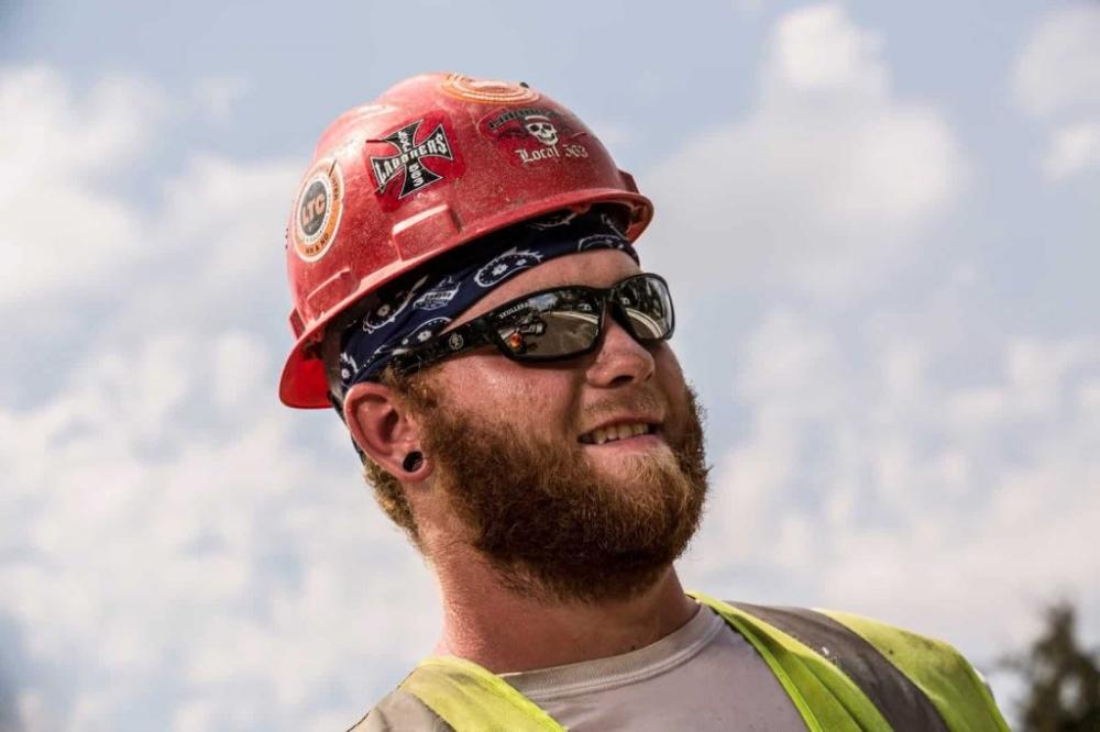 Worker with an evaporative cooling bandana under his hard hat to stay cool