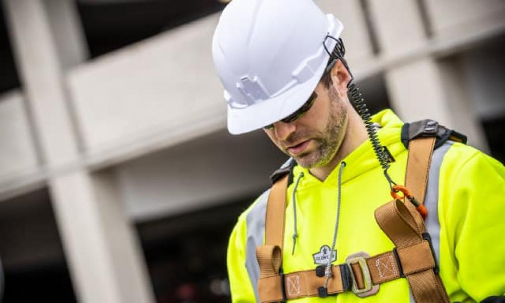 Head down, helmet on. Hi vis vest