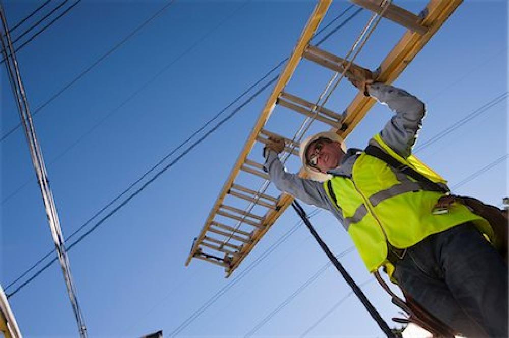 man carrying a ladder overhead