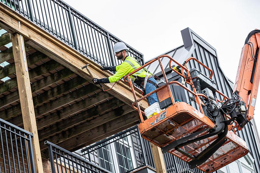 man in a scissor lift with a fall restraint